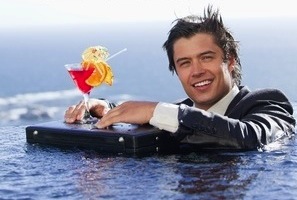 11686470-portrait-of-a-businessman-relaxing-in-a-swimming-pool-with-a-cocktail-in-a-suit